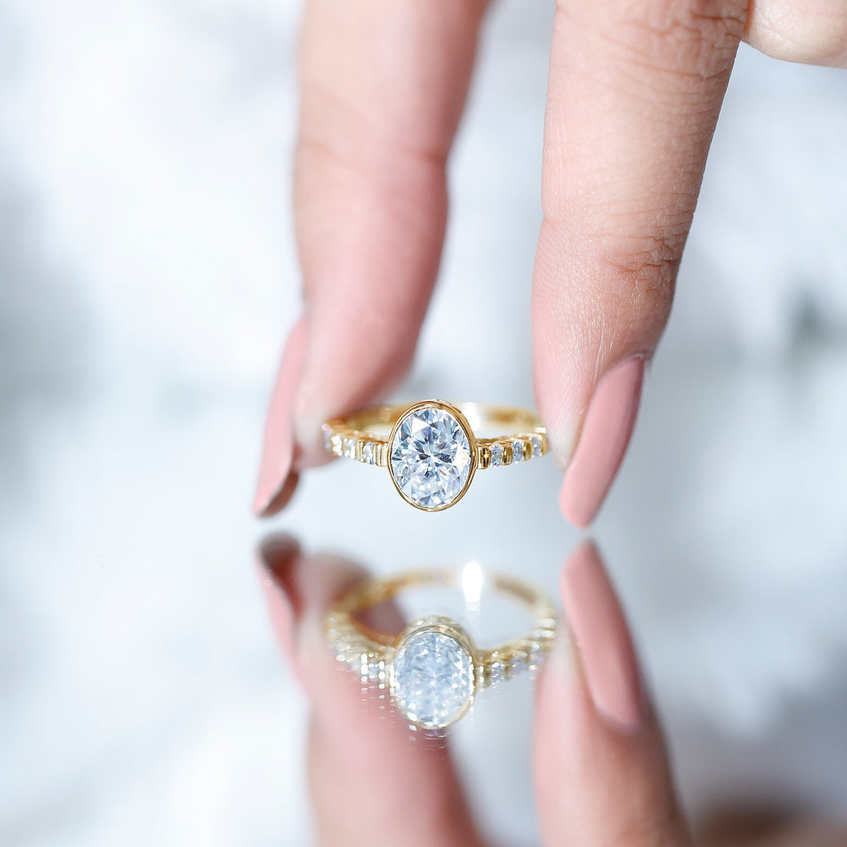 Bezel Set Moissanite Oval Engagement Ring with Side Stones