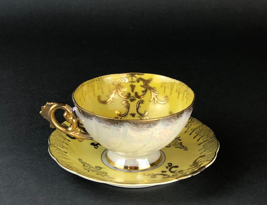 Antique Cup and Saucer Set by Royal Sealy China, Japan. Yellow Cup and Saucer with Rich Gold Decor and Iridescent Background Outside.