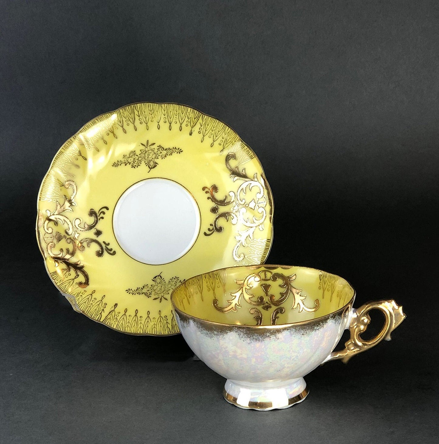 Antique Cup and Saucer Set by Royal Sealy China, Japan. Yellow Cup and Saucer with Rich Gold Decor and Iridescent Background Outside.