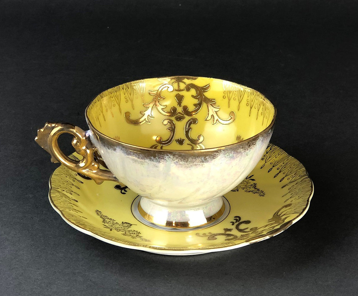 Antique Cup and Saucer Set by Royal Sealy China, Japan. Yellow Cup and Saucer with Rich Gold Decor and Iridescent Background Outside.